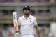 England captain Alastair Cook holds up his bat to acknowledge applause from the crowd as he walks off the field of play after losing his wicket off the bowling of Ravindra Jadeja, scoring 95 runs during the first day of the third cricket test match of the series between England and India at The Ageas Bowl in Southampton, England, Sunday, July 27, 2014. (AP Photo/Matt Dunham)