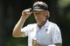 Bernhard Langer tips his visor on the third green during the final round of the 2014 U.S. Senior Open golf tournament at Oak Tree National in Edmond, Okla., Sunday, July 13, 2014. (AP Photo/Sue Ogrocki)