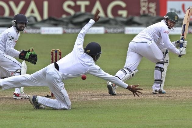 South African batsman Quinton de Kock, right, looks back after playing a shot as Sri Lanka's Kaushal Silva attempts to stop the ball during the fifth day of the second test cricket match between South Africa and Sri Lanka in Colombo, Sri Lanka, Monday, July 28, 2014. (AP Photo/Sanka Gayashan)