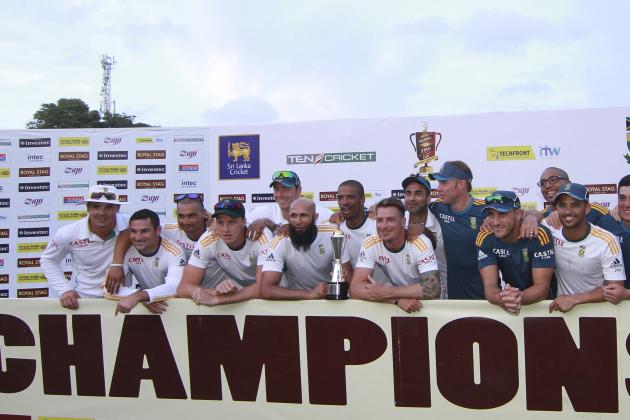 South African cricket team members pose a group photography with the trophy after  their second test cricket match against Sri Lanka was drawn in Colombo, Sri Lanka, Monday, July 28, 2014. South Africa won the two-test series 1-0:  (AP Photo/Sanka Gayashan)