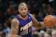 Phoenix Suns forward P.J. Tucker picks up loose ball against the Denver Nuggets in the first quarter of an NBA basketball game in Denver on Tuesday, Feb. 18, 2014. (AP Photo/David Zalubowski)
