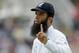 England's Moeen Ali gestures to fans to wait as he fields before signing autographs for them on the edge of the boundary during the second day of the third cricket test match of the series between England and India at The Ageas Bowl in Southampton, England, Monday, July 28, 2014. (AP Photo/Matt Dunham)