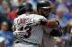 Cleveland Indians' Carlos Santana, right, hugs teammate Asdrubal Cabrera (13) at home plate after hitting a two-run home run in the fifth inning of a baseball game against the Kansas City Royals at Kauffman Stadium in Kansas City, Mo., Thursday, July 24, 2014. (AP Photo/Colin E. Braley)