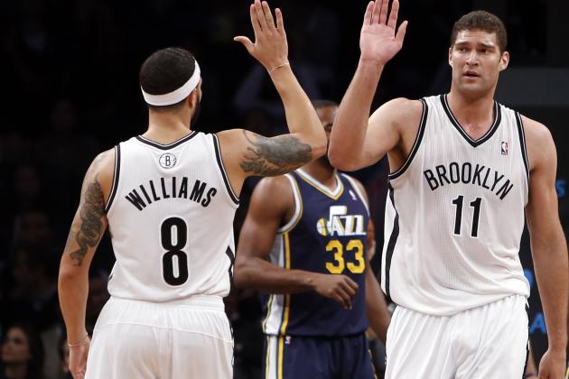 Brooklyn Nets' Deron Williams (8) congratulates teammate Brook Lopez (11) after Lopez scored against the Utah Jazz during the first half of an NBA basketball game Tuesday, Nov. 5, 2013, in New York. Brooklyn defeated Utah 104-88. (AP Photo/Jason DeCrow)
