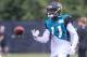 Jacksonville Jaguars receiver Marqise Lee (11) tosses the ball at the end of the play during NFL football practice, first day with pads on Wednesday, July 30, 2014 in Jacksonville, Fla. (AP Photo/Gary McCullough)