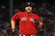 Boston Red Sox catcher David Ross comes up limping after running out a ground ball against the New York Yankees during the sixth inning of a baseball game at Fenway Park in Boston Friday, Aug. 1, 2014. (AP Photo/Winslow Townson)