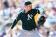 GLENDALE, AZ - MARCH 10: Starting pitcher Jarrod Parker #11 of the Oakland Athletics pitches against the Los Angeles Dodgers during the spring training game at Camelback Ranch on March 10, 2014 in Glendale, Arizona. (Photo by Christian Petersen/Getty Images)