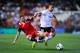 VALENCIA, SPAIN - SEPTEMBER 22: Fede Cartabia (R) of Valencia CF duels for the ball with Alberto Moreno of Sevilla FC during the La Liga match between Valencia CF and Sevilla FC at Estadio Mestalla on September 22, 2013 in Valencia, Spain. (Photo by David Ramos/Getty Images)