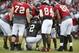 Atlanta Falcons quarterback Matt Ryan (2) huddles with members of the offense including; tackle Sam Baker (72), wide receiver Roddy White (84), and tight end Levine Toilolo (80) during the Falcons annual event, Friday Night Lights, at Archer High School Friday, Aug. 1, 2014, in Lawrenceville, Ga. The Falcons continued their tradition of staging a practice at an area high school each year. (AP Photo/Jason Getz)