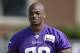 Minnesota Vikings running back Adrian Peterson walks to the field before an NFL football training camp practice, Saturday, Aug. 2, 2014, in Mankato, Minn. (AP Photo/Charlie Neibergall)