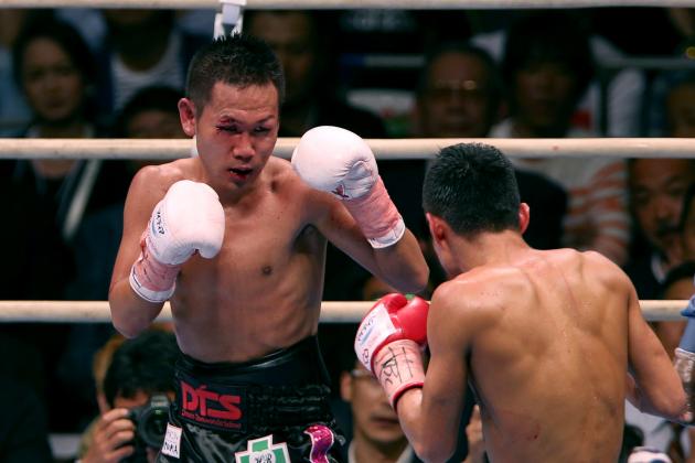 OSAKA, JAPAN - MAY 07: Katsunari Takayama (L) of Japan exchanges punches with Shin Ono during the IBF minimumweight title bout between Katsunari Takayama of Japan and Shin Ono of Japan at the Bodymaker Colosseum on May 7, 2014 in Osaka, Japan. (Photo by Buddhika Weerasinghe/Getty Images)