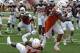 Texas running back Malcolm Brown (28) rushes for a touchdown against Chevoski Collins (14) during the first half of the Orange and White spring NCAA college football game on Saturday, April 19, 2014, in Austin, Texas. (AP Photo/Michael Thomas)