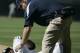 San Diego Padres' Milton Bradley is attended to by trainer Todd Hutchinson after Bradley was injured while being restrained by manager Bud Black during an altercation in the eighth inning of the Padres' 7-3 loss to the Colorado Rockies in their baseball game in San Diego, Sunday Sept. 23, 2007. (AP Photo/Lenny Ignelzi)