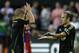 Los Angeles Galaxy forward Landon Donovan, right, is greeted by Seattle Sounders midfielder Osvaldo Alonso, left, after Donovan scored a coal against Bayern Munich in the second half of the MLS soccer All-Star match, Wednesday, Aug. 6, 2014, in Portland, Ore. (AP Photo/Ted S. Warren)