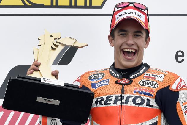 First placed Marc Marquez from Spain lifts his trophy during the award ceremony for the MotoGP race at the Sachsenring circuit in Hohenstein-Ernstthal, Germany, Sunday, July 13, 2014. (AP Photo/Jens Meyer)
