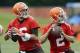 Cleveland Browns quarterbacks Brian Hoyer (6) and Johnny Manziel (2) drop back to pass during a mandatory minicamp practice at the NFL football team's facility in Berea, Ohio Tuesday, June 10, 2014. (AP Photo/Mark Duncan)