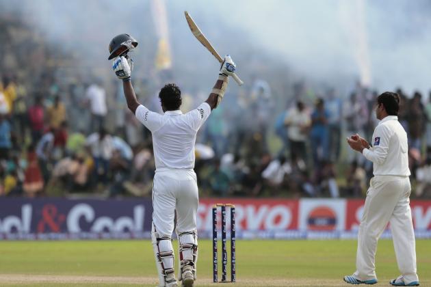 Sri Lankan batsman Kumar Sangakkara, left, celebrates scoring a double century as Pakistan's Saeed Ajmal applauds during the fourth day of the first test cricket match between Sri Lanka and Pakistan in Galle, Sri Lanka, Saturday, Aug. 9, 2014. (AP Photo/Eranga Jayawardena)