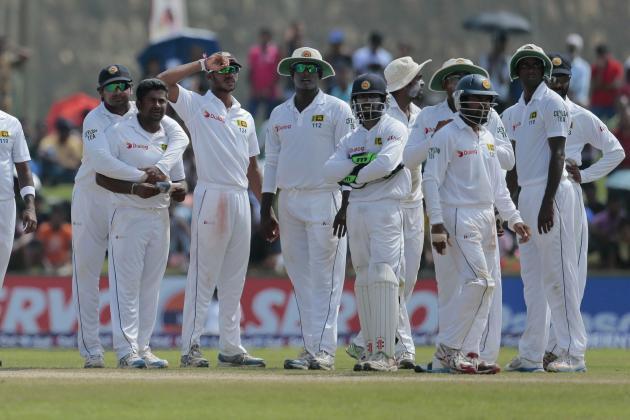 Sri Lankan bowler Rangana Herath, third left, along with teammates await a successful third umpire decision over Pakistani batsman Asad Shafiq during the fifth day of the first test cricket match in Galle, Sri Lanka, Sunday, Aug. 10, 2014. (AP Photo/Eranga Jayawardena)