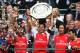 LONDON, ENGLAND - AUGUST 10: Captain Mikel Arteta of Arsenal holds up the trophy alongside team-mates Alex Oxlade-Chamberlain (L) Tomas Rosicky and Santi Cazorla after winning the FA Community Shield match between Manchester City and Arsenal at Wembley Stadium on August 10, 2014 in London, England. (Photo by Clive Mason/Getty Images)