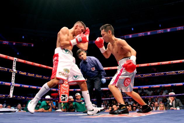 Mexico's Francisco Rodriguez, left, exchanges a punch with Japan's Katsunari Takayama, during their IBF and WBO minimumweight title unification in Monterrey, Mexico, Saturday Aug. 9, 2014. (AP Photo/Alfredo Lopez)