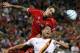 Liverpool FC defender Daniel Agger, top, challenges AS Roma's Marco Borriello (9) for the ball during a friendly soccer match at Fenway Park in Boston, Wednesday, July 23, 2014. (AP Photo)