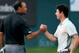 DUBAI, UNITED ARAB EMIRATES - JANUARY 31: Rory McIlroy of Northern Ireland and Tiger Woods of the USA shake hands on the 18th greenduring the second round of the 2014 Omega Dubai Desert Classic on the Majlis Course at the Emirates Golf Club on January 31, 2014 in Dubai, United Arab Emirates. . (Photo by Francois Nel/Getty Images)