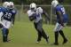 Indianapolis Colts running back Trent Richardson (34) runs past defensive end Cory Redding (90) during NFL football training camp Tuesday, Aug. 12, 2014, in Anderson, Ind. (AP Photo/Darron Cummings)