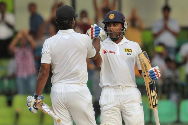Sri Lankan batsmen Mahela Jayawardene, right, and Kumar Sangakkara cheer each other during the third day of the second test cricket match between Sri Lanka and Pakistan in Colombo, Sri Lanka, Saturday, Aug. 16, 2014. (AP Photo/Eranga Jayawardena)