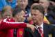 Manchester United's manager Louis van Gaal, right, takes his seat alongside assistant coach Ryan Giggs before the team's English Premier League soccer match against Swansea City at Old Trafford Stadium, Manchester, England, Saturday Aug. 16, 2014. (AP Photo/Jon Super)