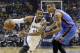 Memphis Grizzlies guard Mike Conley (11) drives against Oklahoma City Thunder guard Thabo Sefolosha during the first half of Game 3 of an opening-round NBA basketball playoff series Thursday, April 24, 2014, in Memphis, Tenn. (AP Photo/Mark Humphrey)