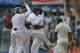 Sri Lankan players lift their bowler Rangana Herath as they celebrate the wicket of Pakistan's Asad Shafiq during the fourth day of the second test cricket match in Colombo, Sri Lanka, Sunday, Aug.17, 2014. (AP Photo/Eranga Jayawardena)