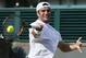 Malek Jaziri of Tunisia returns against Gael Monfils of France during their first round match at the All England Lawn Tennis Championships in Wimbledon, London, Tuesday, June 24, 2014. (AP Photo/Alastair Grant)