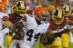 Cleveland Browns running back Ben Tate (44) runs from Washington Redskins defensive end Jarvis Jenkins (99) and linebacker Keenan Robinson (52) during the first half of an NFL preseason football game Monday, Aug. 18, 2014, in Landover, Md. (AP Photo/Richard Lipski)