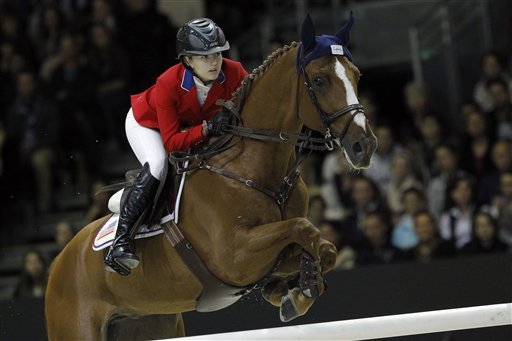 Lucy Davis of U.S rides her horse Barron during the FEI World Cup Jumping Final in Lyon, central France, Monday April 21, 2014. (AP Photo/Laurent Cipriani)