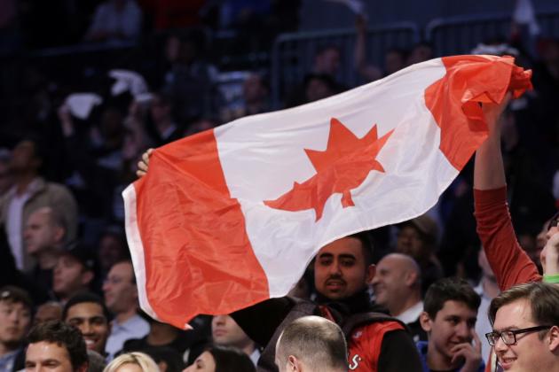 Toronto Raptors fans hold up a Canadian flag during the second half of Game 3 of an NBA basketball first-round playoff series against the Brooklyn Nets Friday, April 25, 2014, in New York. The Nets won the game 102-98. (AP Photo/Frank Franklin II)