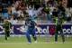 DUBAI, UNITED ARAB EMIRATES - DECEMBER 20: Thisara Perera of Sri Lanka bats as Umar Akmal of Pakistan looks on during the second One-Day International (ODI ) match between Sri Lanka and Pakistan at the Dubai Sports City Cricket Stadium on December 20, 2013 in Dubai, United Arab Emirates. (Photo by Francois Nel/Getty Images)