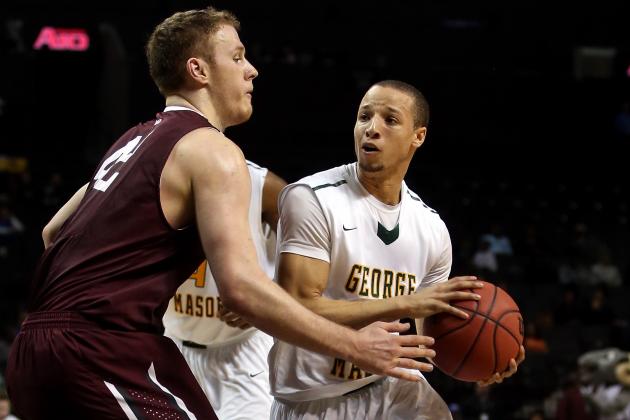 NEW YORK, NY - MARCH 12: Patrick Holloway #3 of the George Mason Patriots handles the ball against Ryan Canty #42 of the Fordham Rams in the second half during the first round of the Atlantic 10 Men's Basketball Tournament at Barclays Center on March 12, 2014 in the Brooklyn Borough of New York City. (Photo by Mike Lawrie/Getty Images)