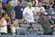 Comedian Chris Rock, far right, offers a foul ball he caught off Houston Astros' Marwin Gonzalez to a youngster after catching it in the seventh inning of a baseball game against the New York Yankees at Yankee Stadium in New York, Thursday, Aug. 21, 2014. (AP Photo/Kathy Willens)