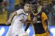 Erik Lamela of Tottenham, left, control the ball by Diallo Guidileye, right, of AEL during their Europa League play-offs first leg soccer match at Antonis Papadopoulos stadium in Larnaca, Cyprus, Thursday, Aug. 21, 2014. Tottenham won the match 2-1. (AP Photo/Petros Karadjias)