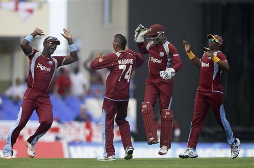 From left, West Indies' Darren Sammy, Sunil Narine, Denesh Ramdin and captain Dwayne Bravo celebrate taking the wicket of  England's Luke Wright during their second one-day international cricket match at the Sir Vivian Richards Cricket Ground in St. John's, Antigua, Sunday, March 2, 2014. (AP Photo/Ricardo Mazalan)
