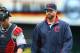 Cleveland Indians starting pitcher Corey Kluber, right, heads to the dugout with catcher Yan Gomes before the first inning of a baseball game, Thursday, Aug. 21, 2014, in Minneapolis. (AP Photo/Jim Mone)