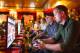 IMAGE DISTRIBUTED FOR 2K - Giant Bomb's Alex Navarro and GameSpot's Giancarlo Varanini play WWE 2K15 at the video game's press event at Cicada Restaurant, on Saturday, August 16, 2014 in Los Angeles. (Photo by Colin Young-Wolff/Invision for 2K/AP Images)
