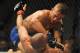 May 24, 2014; Las Vegas, NV, USA; TJ Dillashaw (blue) pins down Renan Barao (red) during their UFC 173 bantamweight championship bout at MGM Grand Garden Arena. Dillashaw won the bout by way of TKO. Mandatory Credit: Stephen R. Sylvanie-USA TODAY Sports