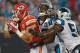 CHARLOTTE, NC - AUGUST 17: Travis Kelce #87 of the Kansas City Chiefs drags Robert Lester #38 and Jason Williams #54 of the Carolina Panthers into the end zone for a touchdown during their game at Bank of America Stadium on August 17, 2014 in Charlotte, North Carolina. Carolina won 28-16. (Photo by Grant Halverson/Getty Images)