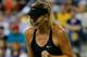 NEW YORK, NY - AUGUST 25: Maria Sharapova of Russia reacts against Maria Kirilenko of Russia during their women's singles match on Day One of the 2014 US Open at the USTA Billie Jean King National Tennis Center on August 25, 2014 in the Flushing neighborhood of the Queens borough of New York City. (Photo by Chris Trotman/Getty Images for USTA)