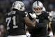 Oakland Raiders quarterback Derek Carr, right, celebrates with Menelik Watson after a Raiders touchdown against the Seattle Seahawks during the first half of an NFL preseason football game in Oakland, Calif., Thursday, Aug. 28, 2014. (AP Photo/Marcio Jose Sanchez)
