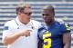 Michigan head coach Brady Hoke, left, speaks with freshman cornerback Jabrill Peppers (5) after a team photo during the NCAA college football team's preseason media day, Sunday, Aug. 10, 2014, at Michigan Stadium in Ann Arbor, Mich. (AP Photo/Tony Ding)