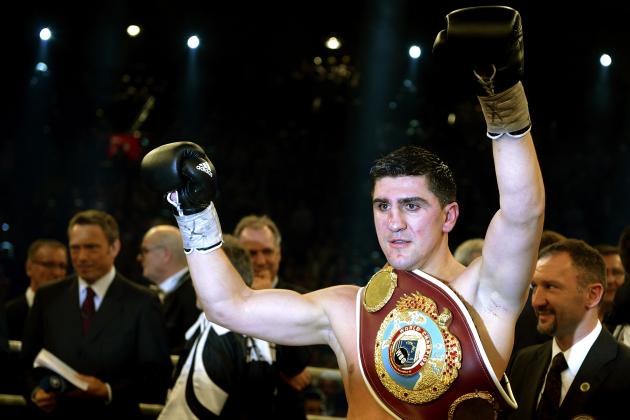 Champion Marco Huck of Germany celebrates after defending his WBO cruiserweight title against challenger Firat Arslan in Stuttgart, Germany, Saturday, Jan. 25, 2014. Huck stopped compatriot Arslan in the sixth round of their rematch to successfully retain his WBO belt for the 12th time. (AP Photo/Daniel Kopatsch)