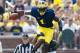 Aug 30, 2014; Ann Arbor, MI, USA; Michigan Wolverines wide receiver Devin Funchess (87) leaps over Appalachian State Mountaineers defensive back Dante Blackmon (24) as linebacker Rashaad Townes (31) grabs him from behind in the first quarter at Michigan Stadium. Mandatory Credit: Rick Osentoski-USA TODAY Sports