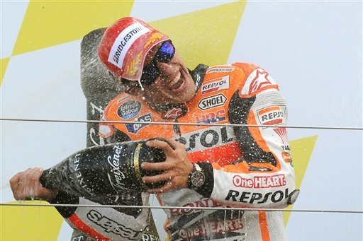 CAPTION CORRECTS THE DATE - Spain's Marc Marquez of Repsol Honda celebrates on the podium after winning the MotoGP British Grand Prix, at Silverstone, England, Sunday, Aug. 31, 2014. (AP Photo/Rui Vieira)